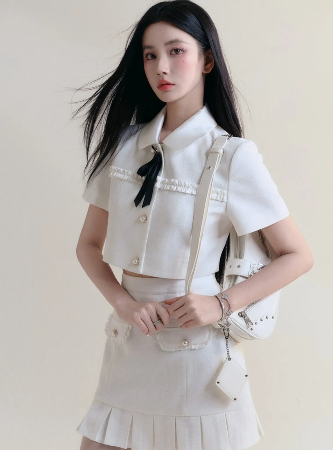 Ivory Elegance Bow-Tie Crop Blouse and Pleated Mini Skirt Set