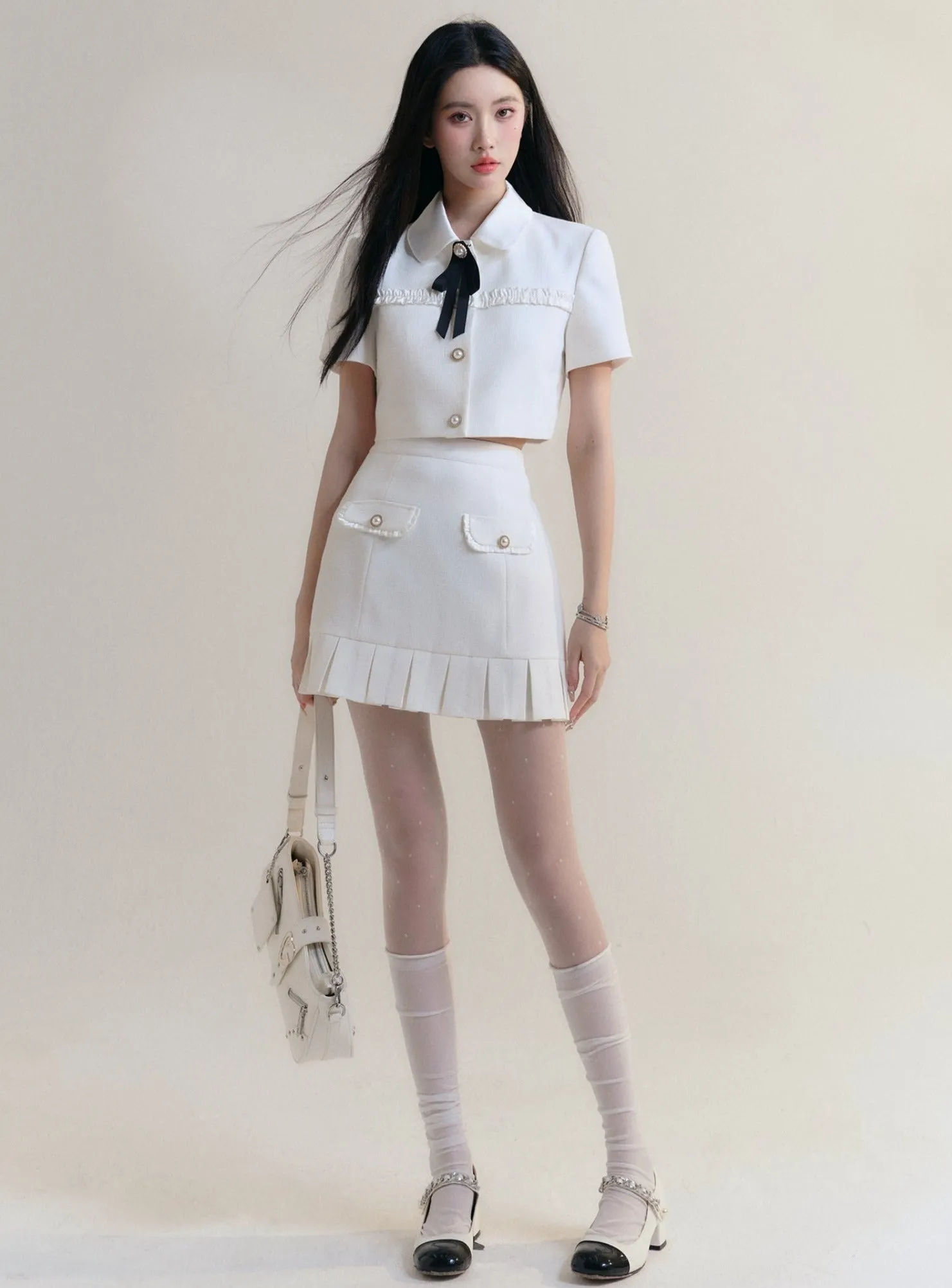 Ivory Elegance Bow-Tie Crop Blouse and Pleated Mini Skirt Set